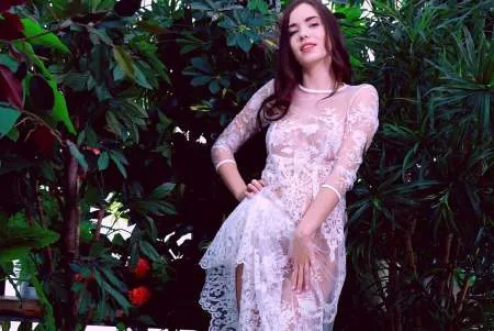 Красива дівчина в прозорій білій сукні в саду (ФОТО)
